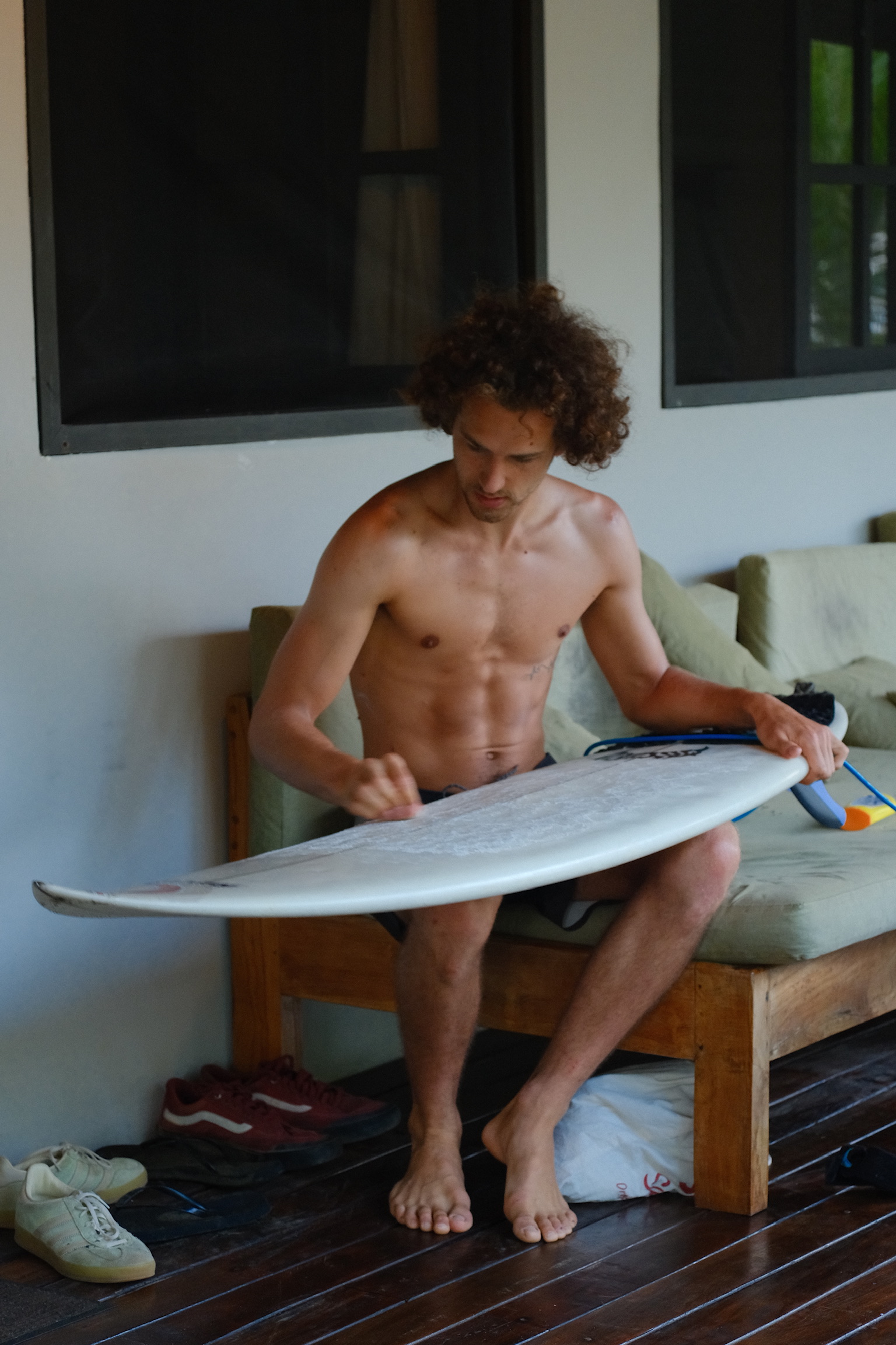 Ben waxing his surfboard before a session